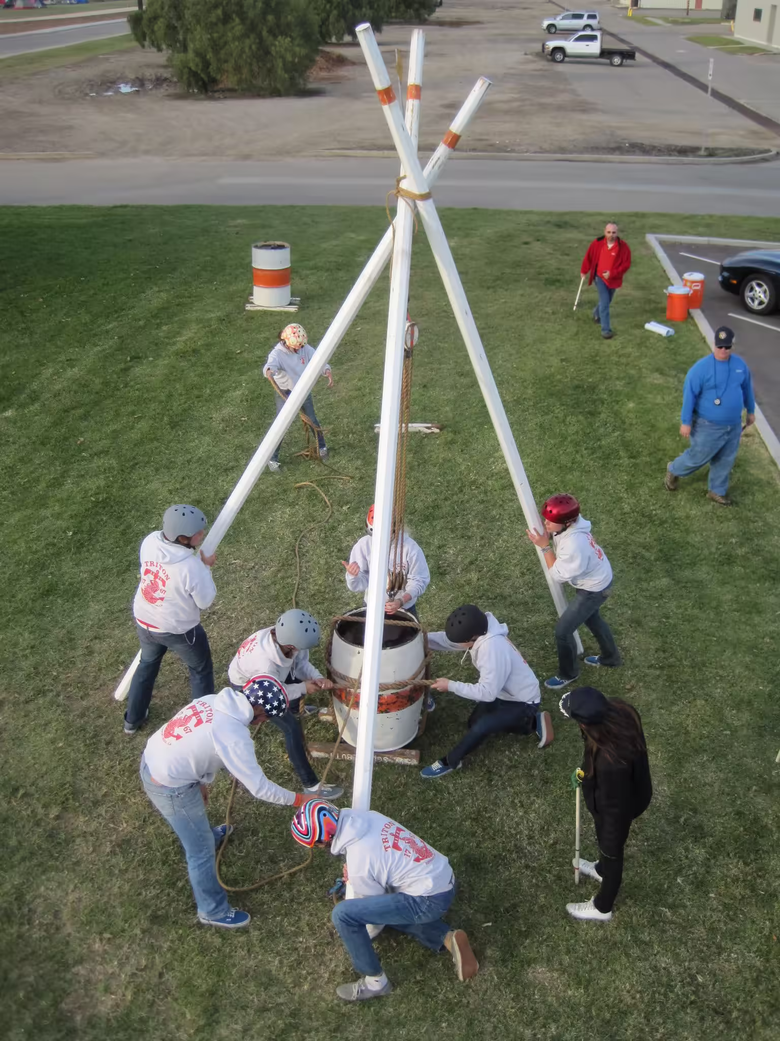 A crew hauling a water barrel up the Scuttlebutt tripod, seen from above